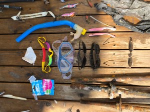 Snorkel, mask, goggles and sunglasses left discarded and lost on the ocean floor