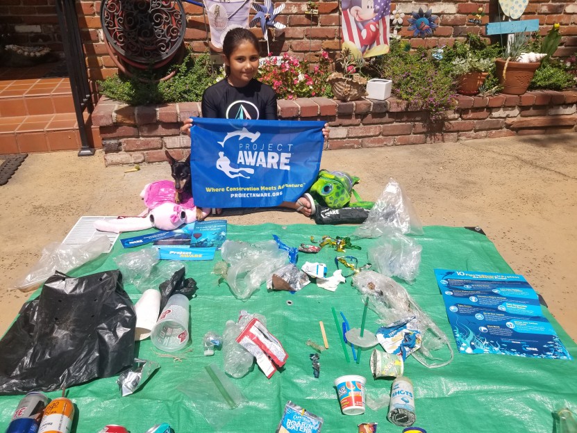 Abigail sorts out the trash and sees lots of plastics!