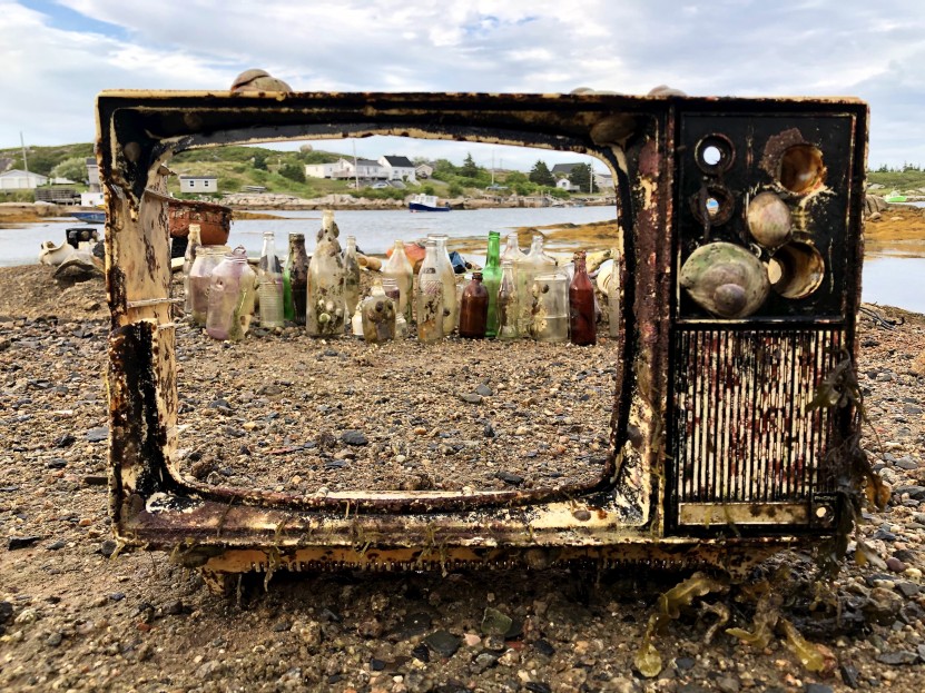 The frame of an old TV recovered from the ocean showcases the trash behind it