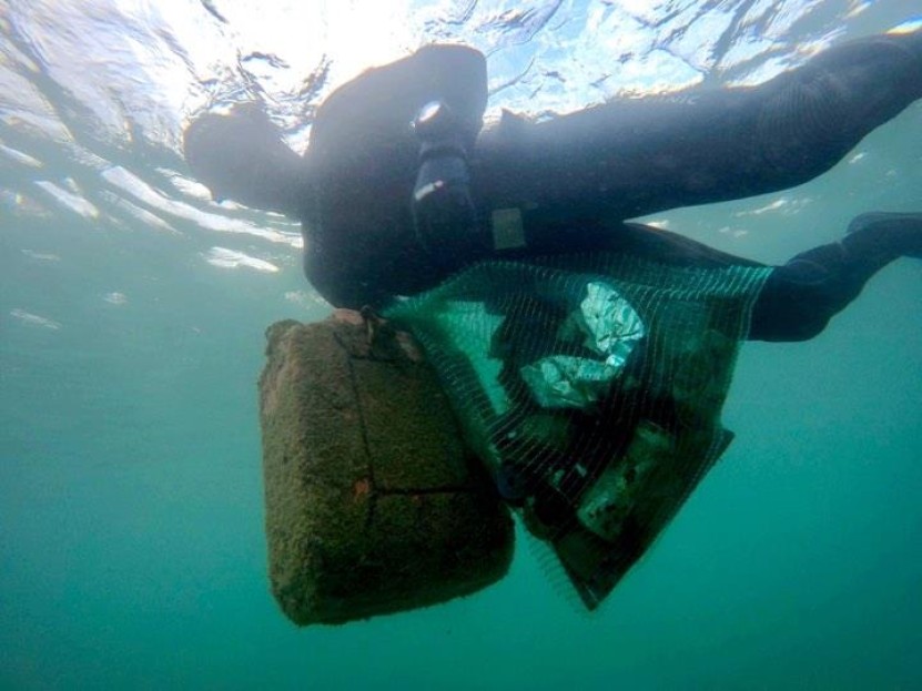 diver carrying debris